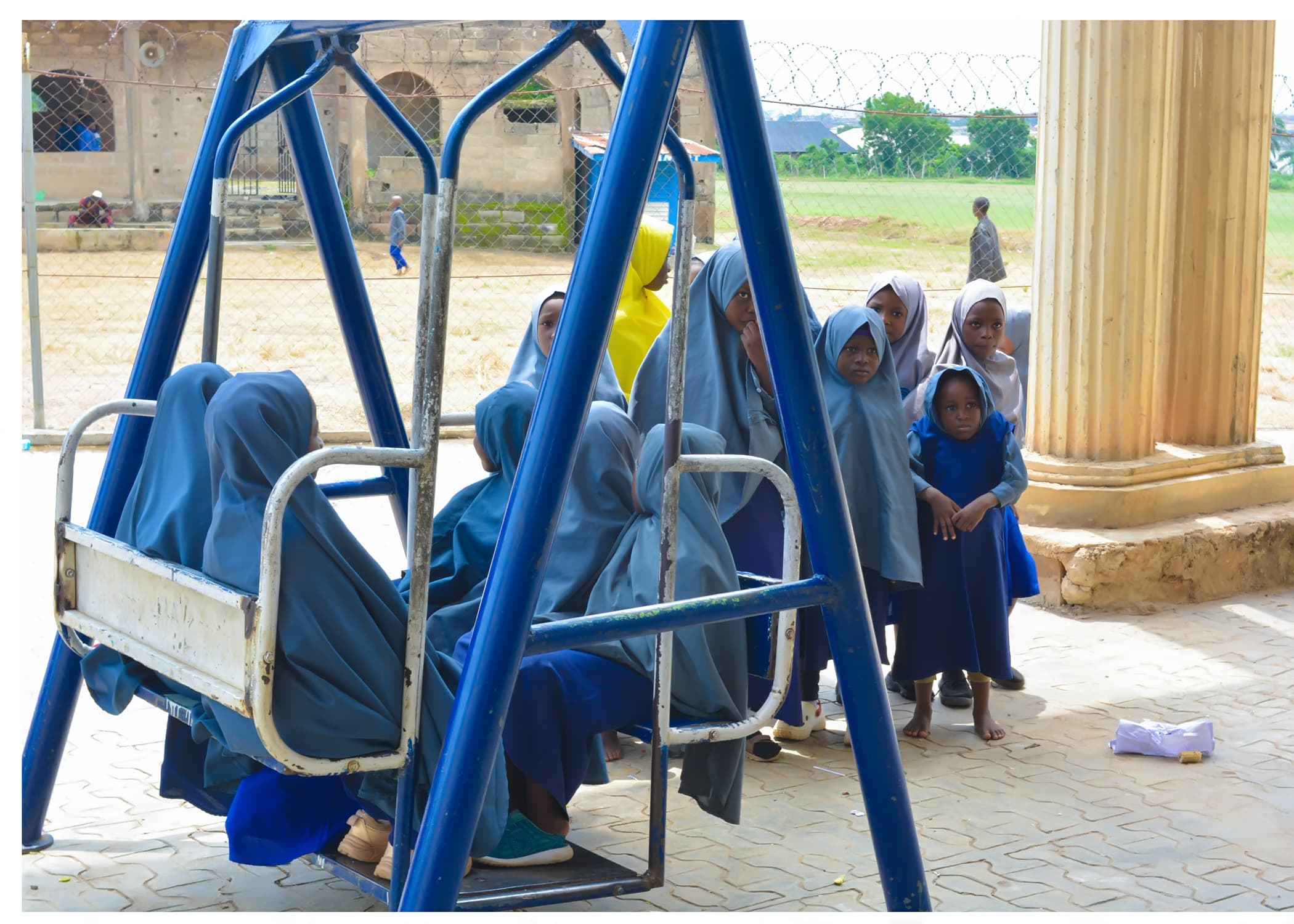 Young Inaayatullah pupils enjoying outdoor play on the school swings