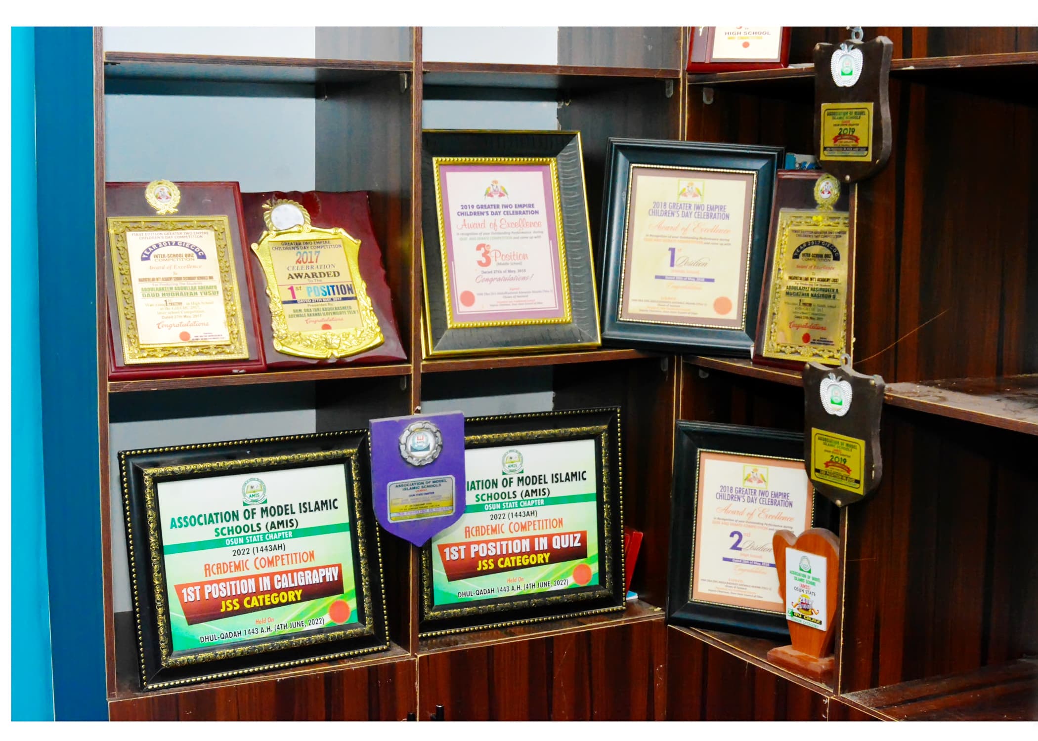 Framed awards and competition certificates earned by Inaayatullah learners