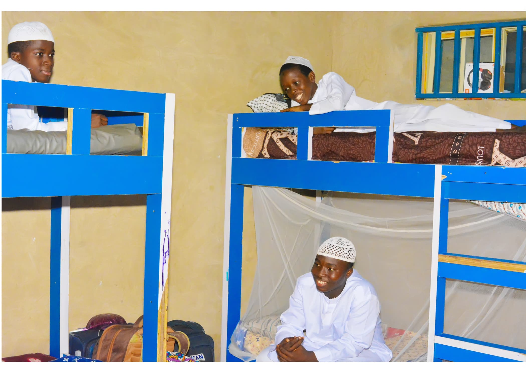 Inaayatullah boarding students relaxing together in their hostel room