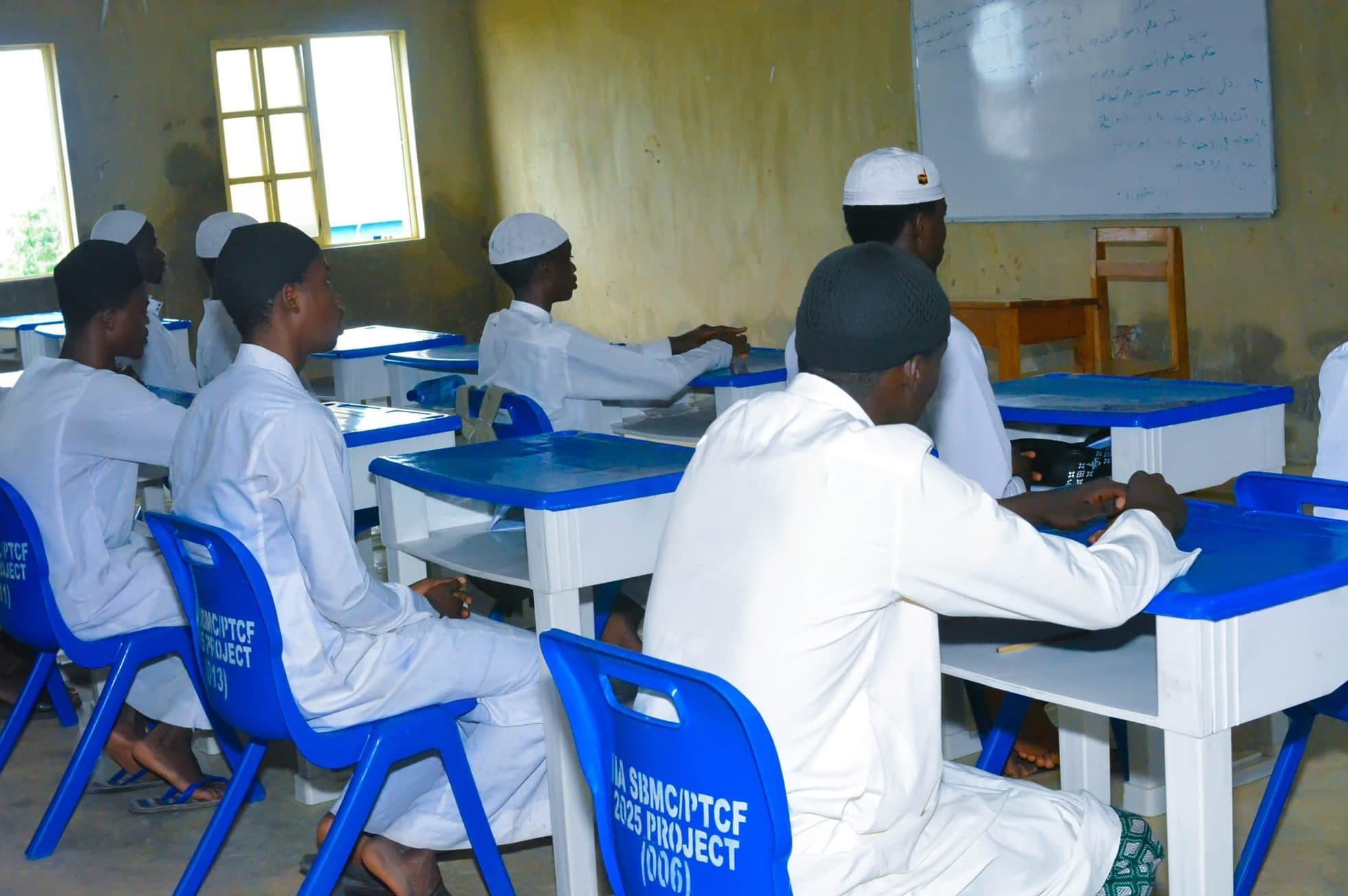 Boys studying at their desks in an Arabic and Islamic studies class