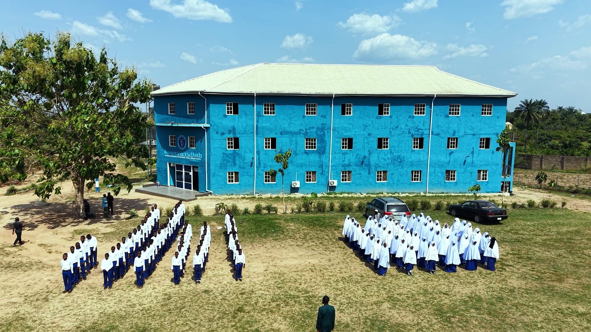 Aerial view of pupils lined up for assembly in front of the Academy building